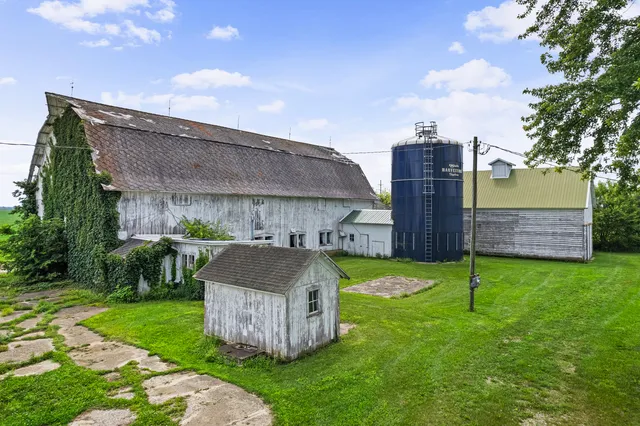 a front view of a house with a garden and yard