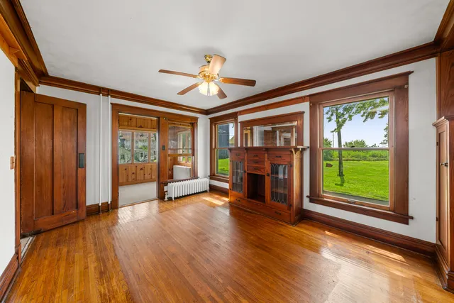 wooden floor in an empty room with a window
