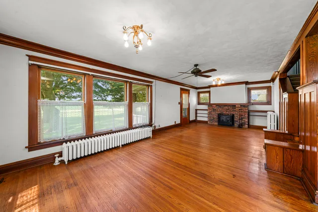 a view of a livingroom with wooden floor and stairs