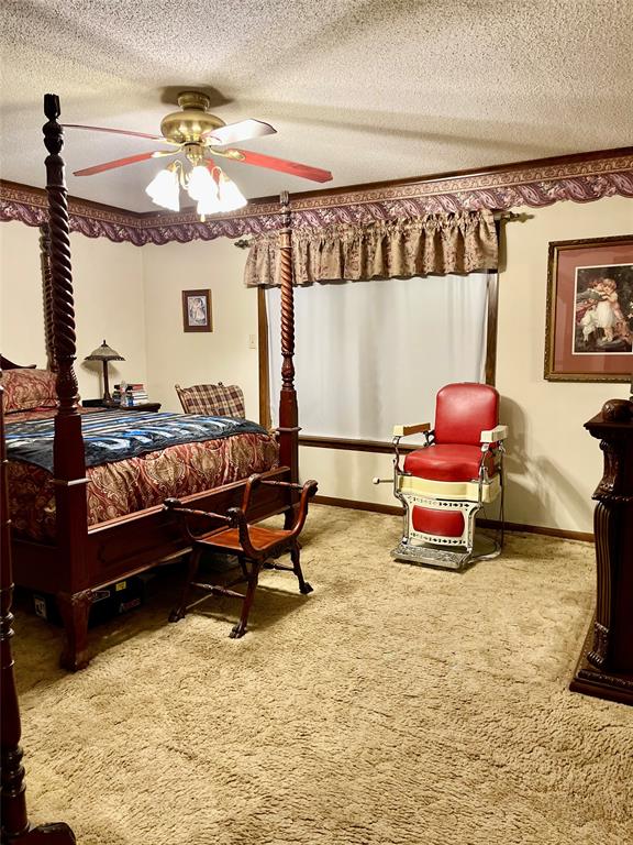 9886 Highway 79 Haynesville, LA 71038 - Photo 14 of 16 a living room with furniture gym equipment and a chandelier