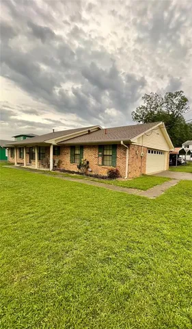 a view of house with outdoor space and swimming pool