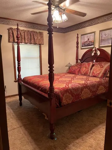 a bedroom with a bed and a mirror