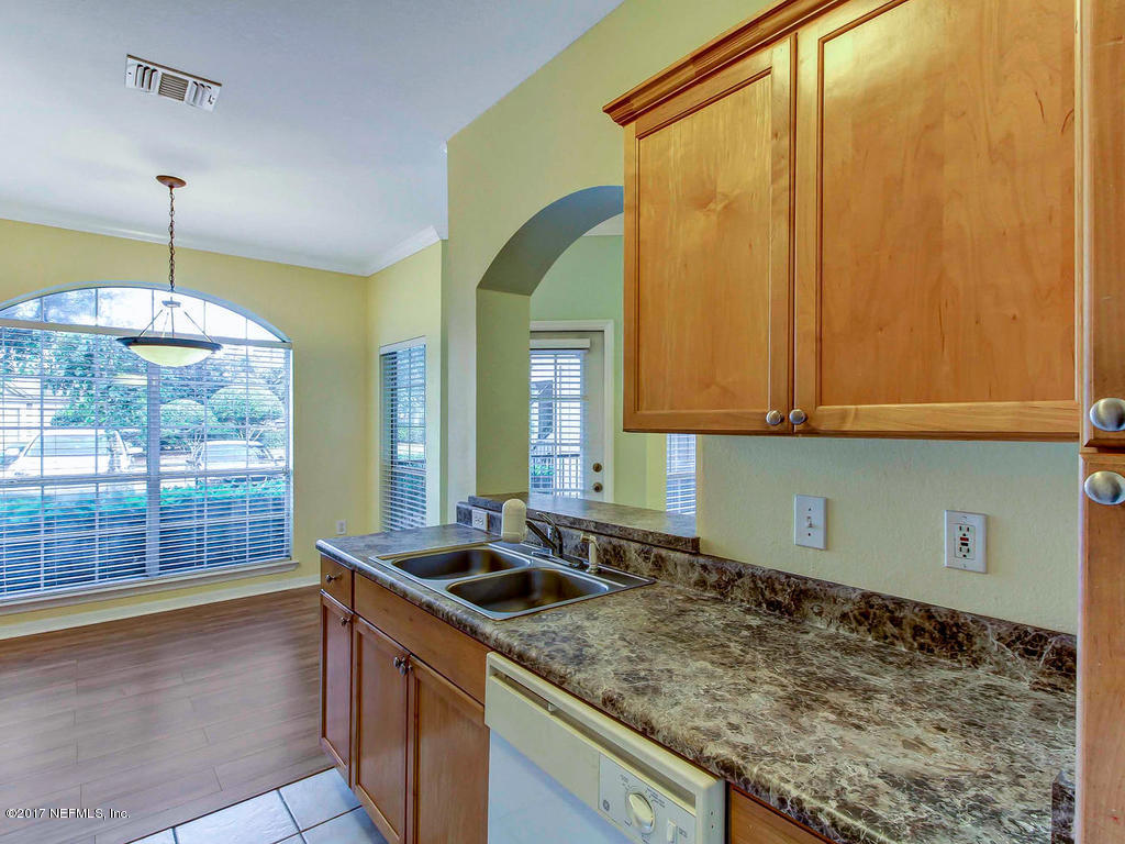 10961 Burnt Mill Road, Unit 1414 Jacksonville, FL 32256 - Photo 14 of 39 a kitchen that has a sink and a stove