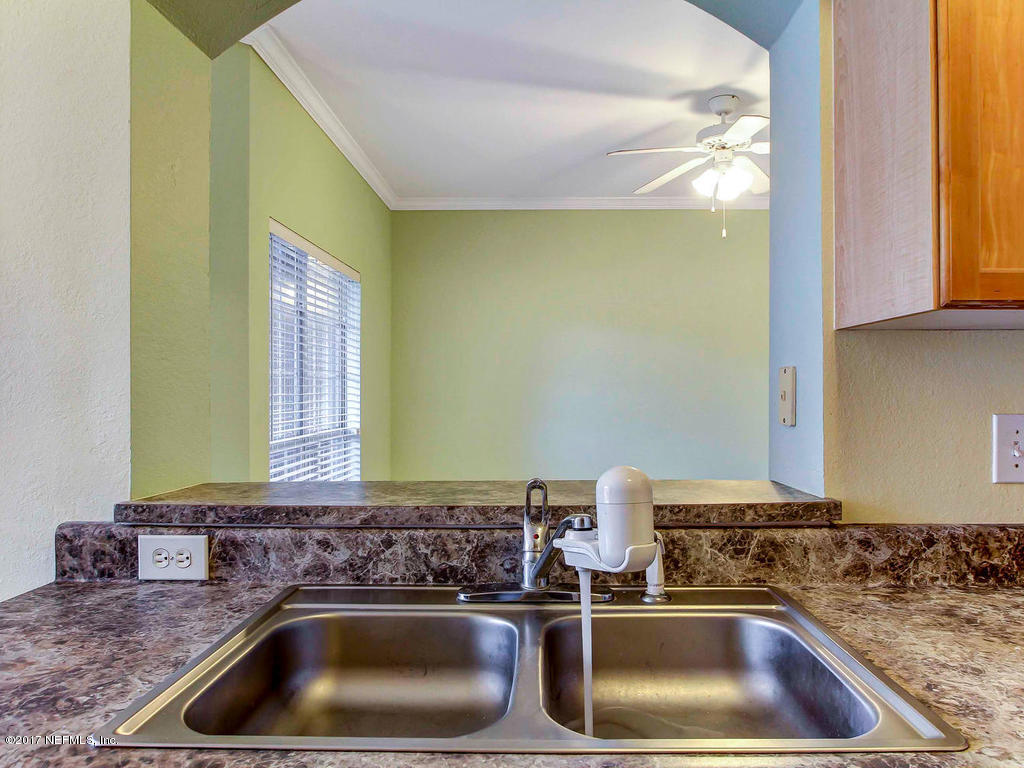 10961 Burnt Mill Road, Unit 1414 Jacksonville, FL 32256 - Photo 15 of 39 a bathroom with a sink and a mirror