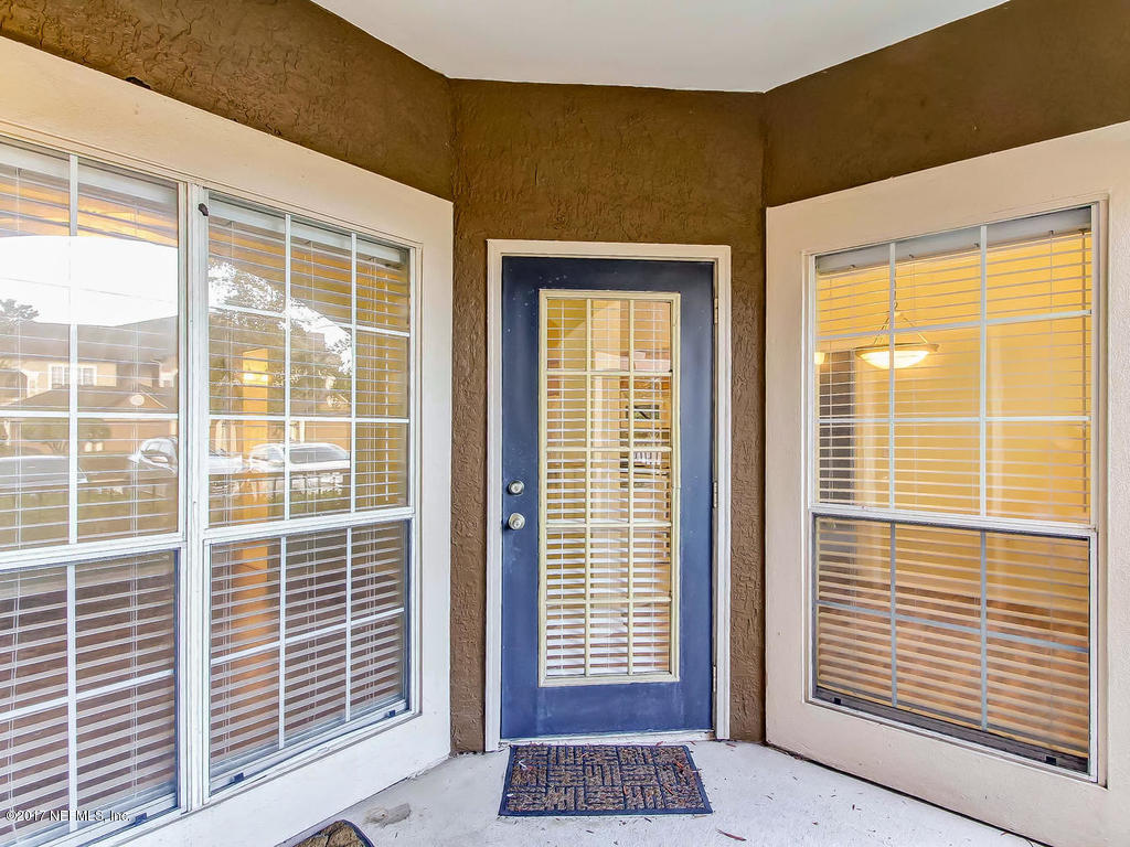 10961 Burnt Mill Road, Unit 1414 Jacksonville, FL 32256 - Photo 17 of 39 a view of wooden door and a window