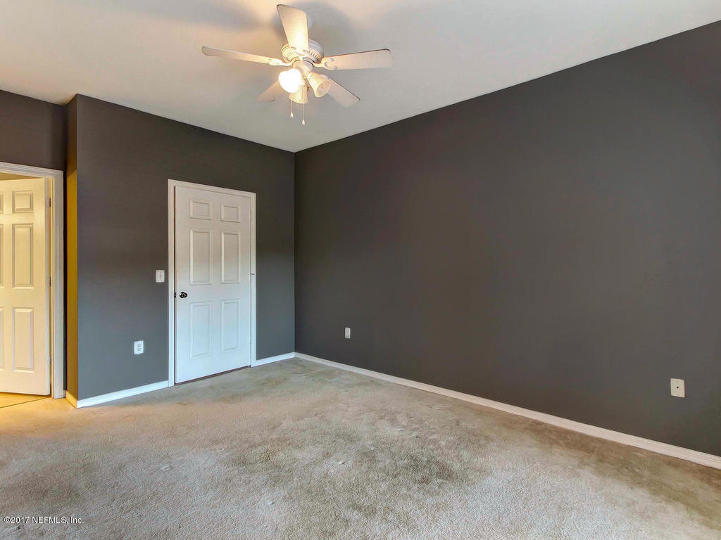 10961 Burnt Mill Road, Unit 1414 Jacksonville, FL 32256 - Photo 18 of 39 an empty room with a ceiling fan and a window