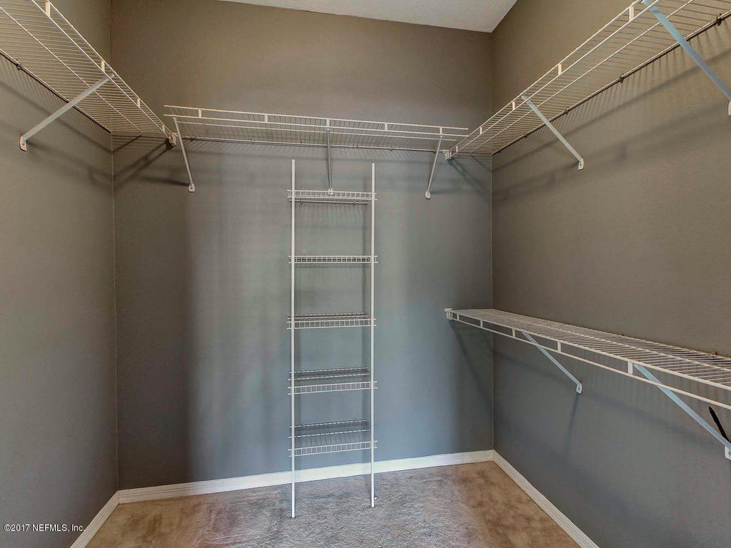 10961 Burnt Mill Road, Unit 1414 Jacksonville, FL 32256 - Photo 21 of 39 a view of walk in closet with clothes