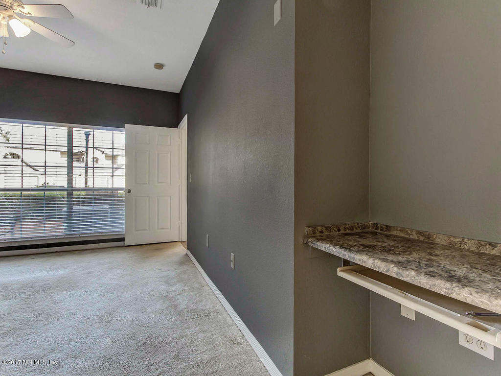 10961 Burnt Mill Road, Unit 1414 Jacksonville, FL 32256 - Photo 22 of 39 an empty room with wooden floor and windows