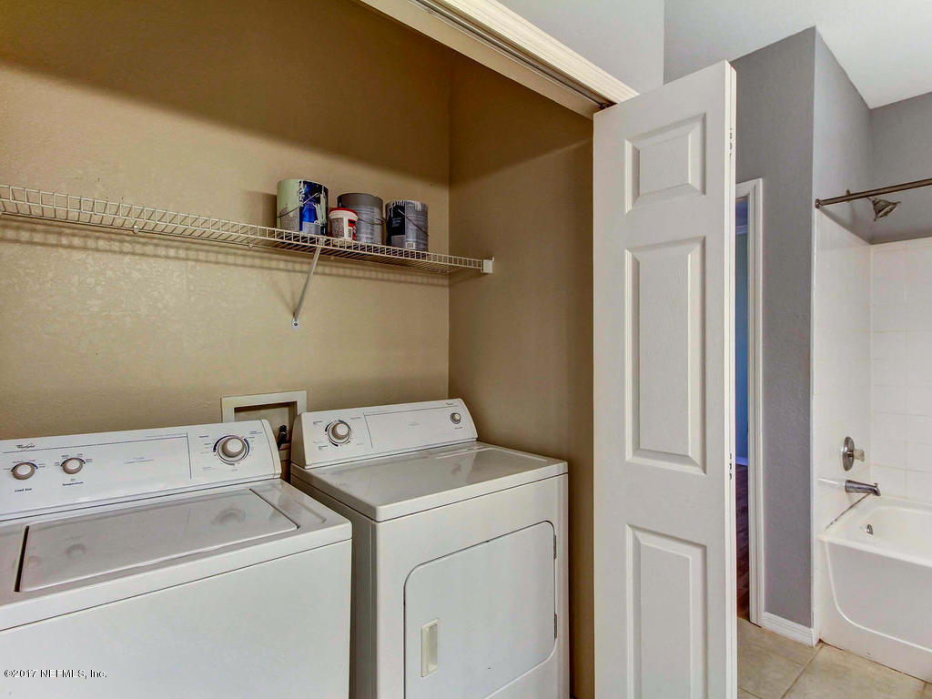 10961 Burnt Mill Road, Unit 1414 Jacksonville, FL 32256 - Photo 24 of 39 a view of storage and utility room with washer and dryer