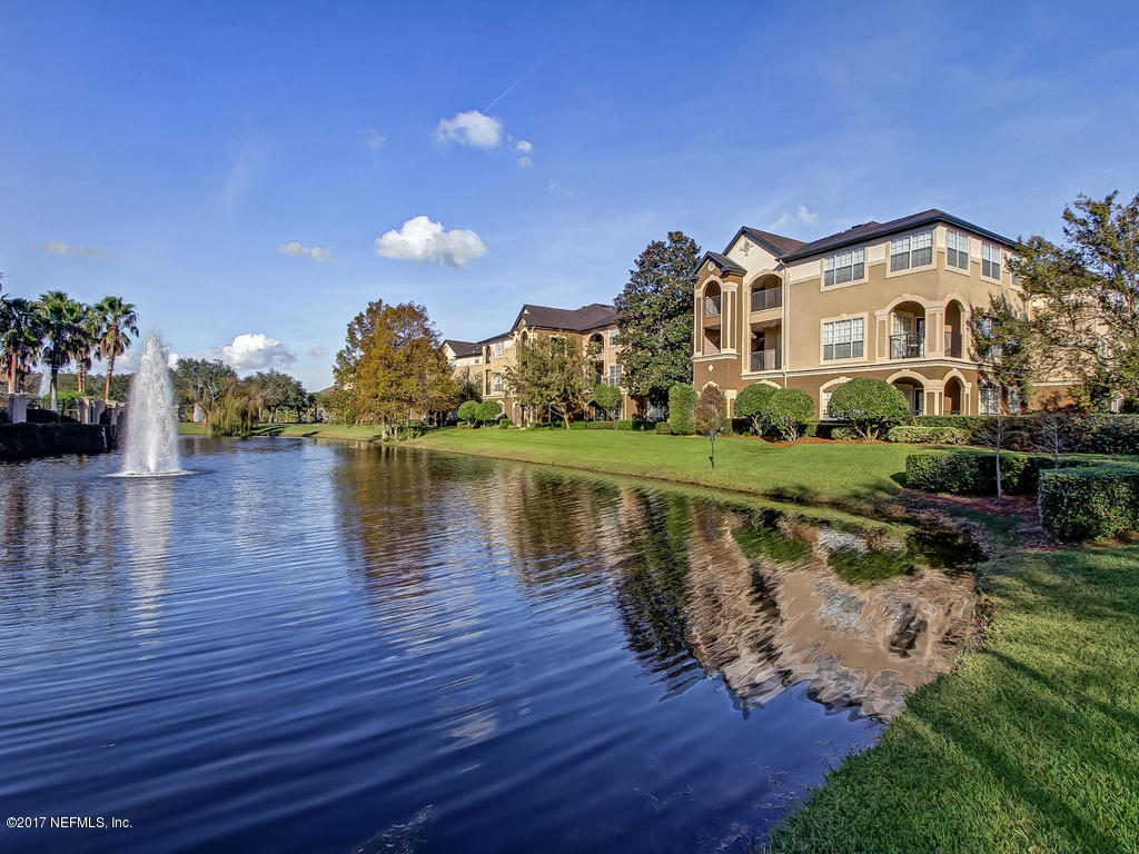 10961 Burnt Mill Road, Unit 1414 Jacksonville, FL 32256 - Photo 27 of 39 a view of a lake with a house in the background