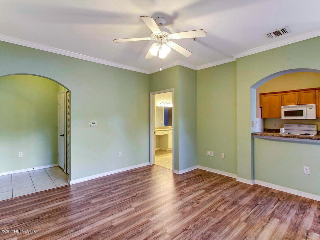 10961 Burnt Mill Road, Unit 1414 Jacksonville, FL 32256 - Photo 7 of 39 wooden floor in an empty room with a window