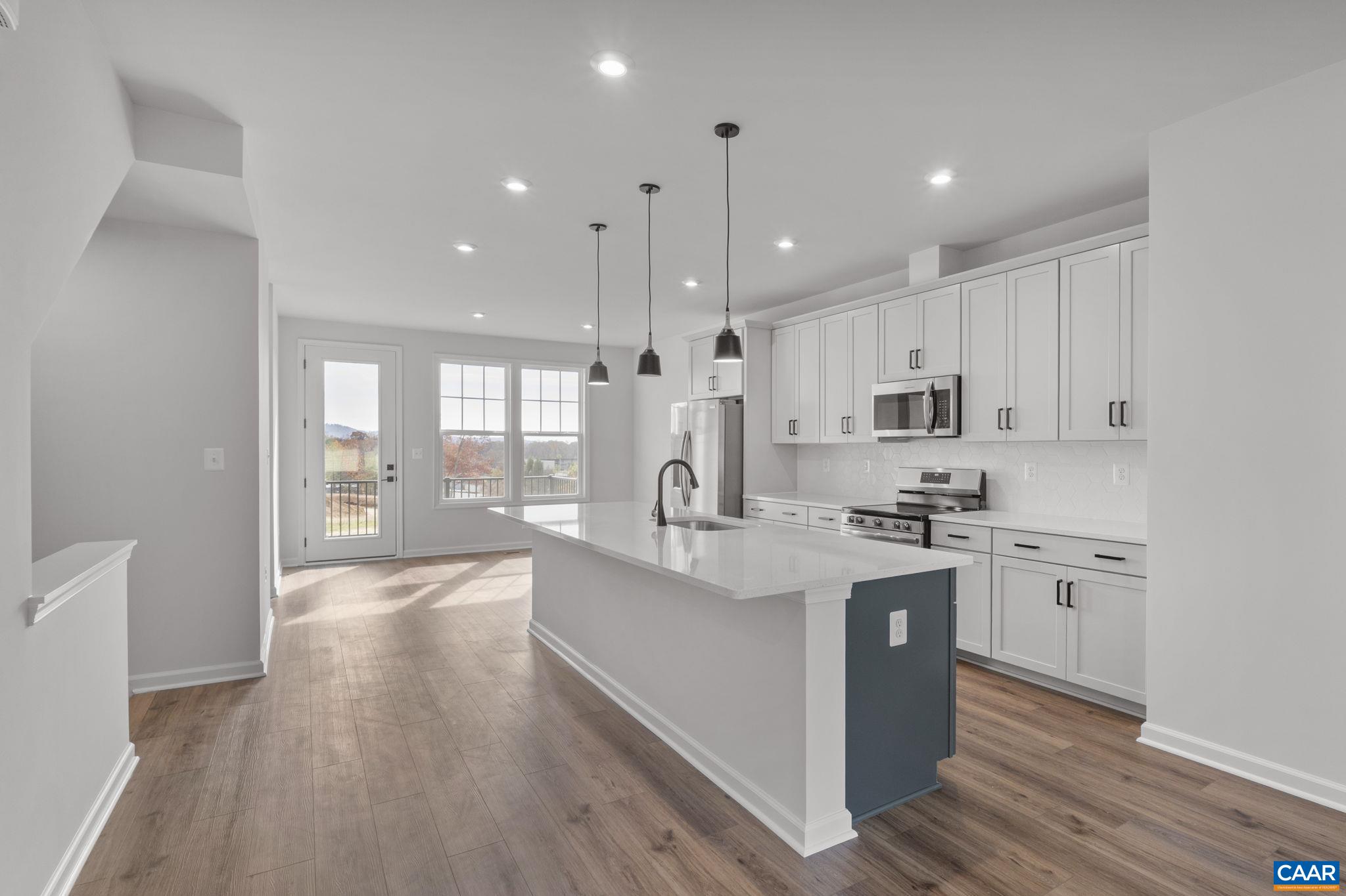 2209 Woodburn Road Charlottesville, VA 22901 - Photo 11 of 41 a large kitchen with stainless steel appliances granite countertop a lot of counter space and wooden floors