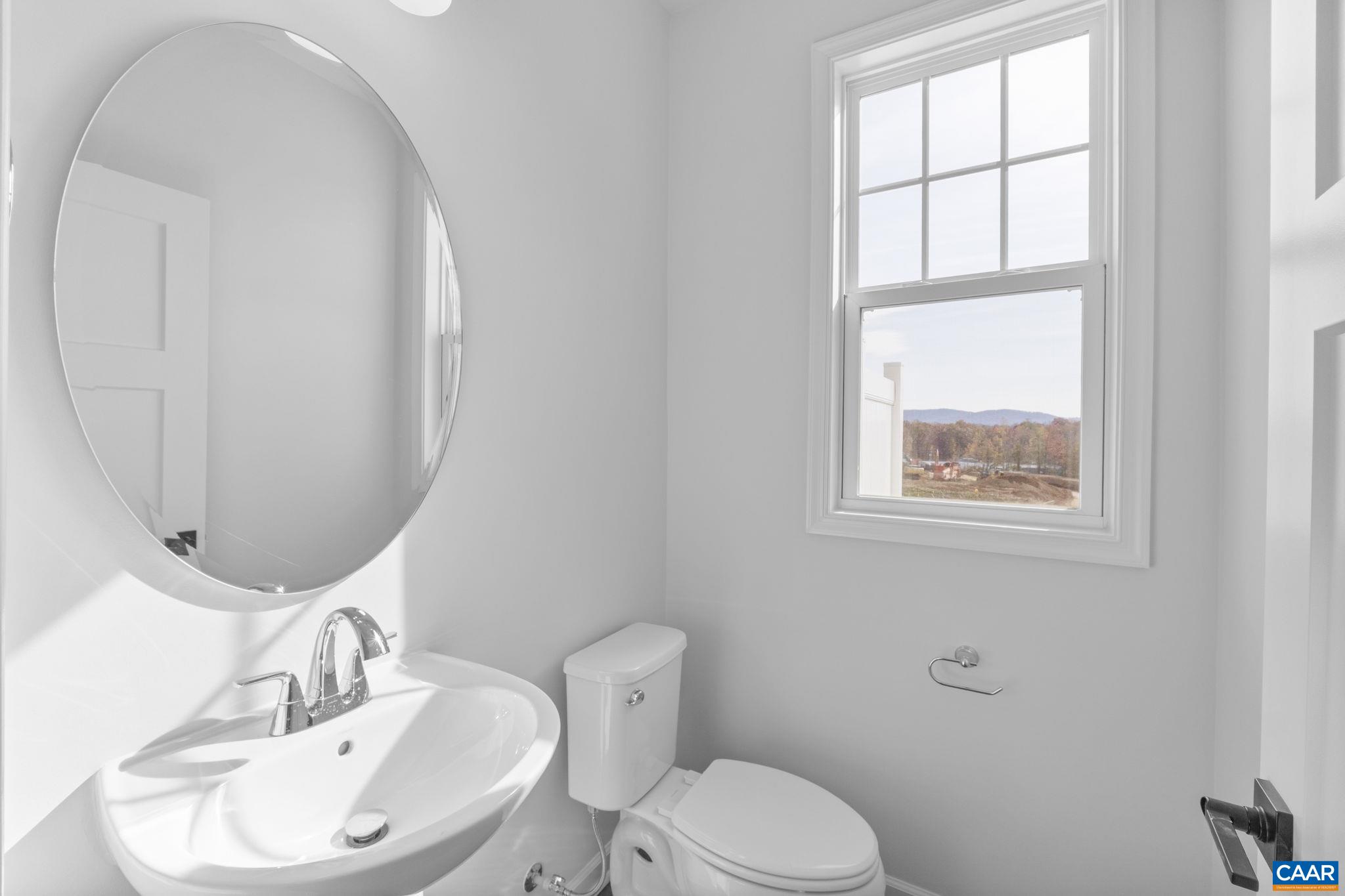2209 Woodburn Road Charlottesville, VA 22901 - Photo 23 of 41 a bathroom with a toilet a sink a mirror and a window