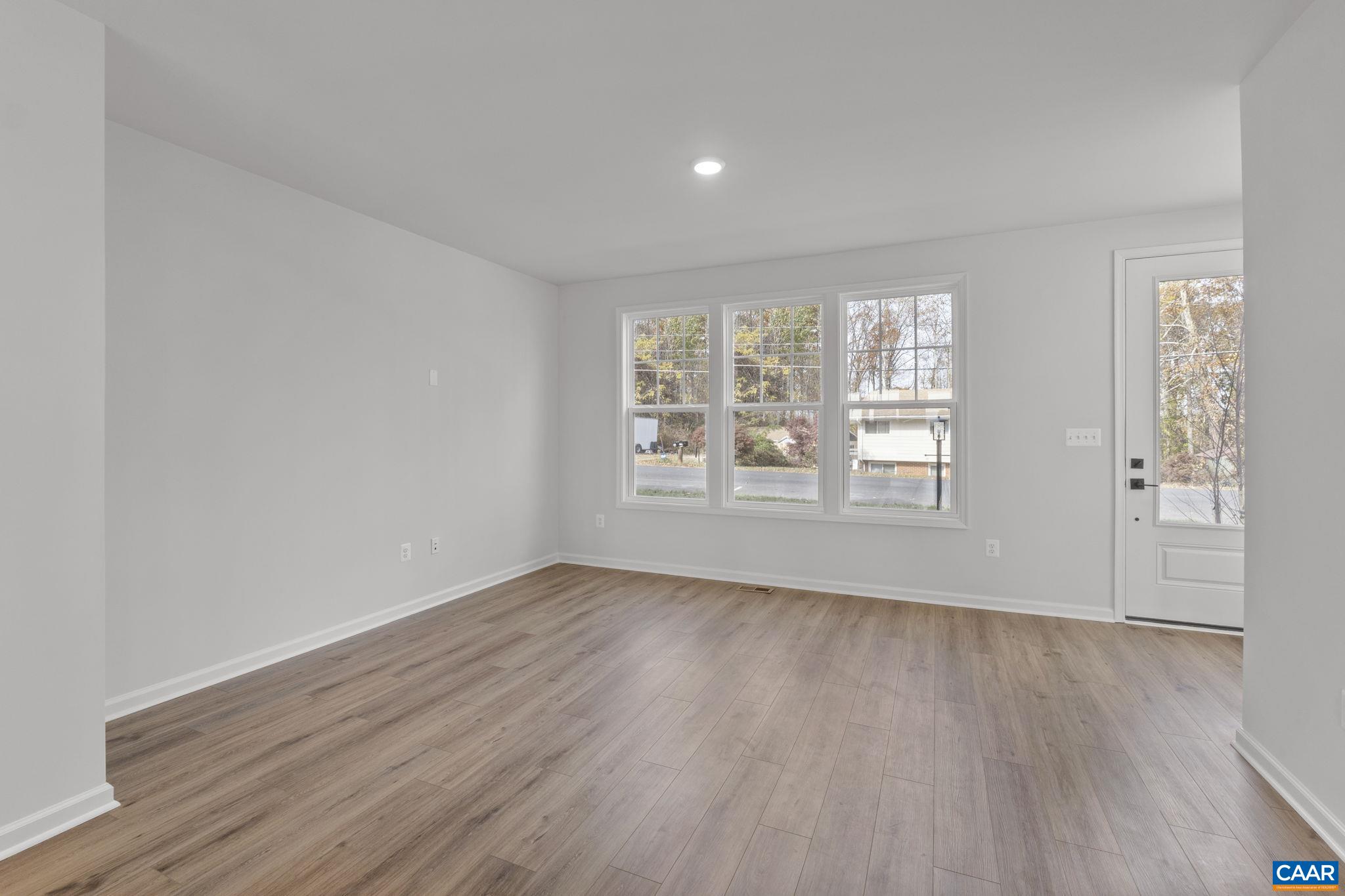 2209 Woodburn Road Charlottesville, VA 22901 - Photo 10 of 41 an empty room with wooden floor and windows