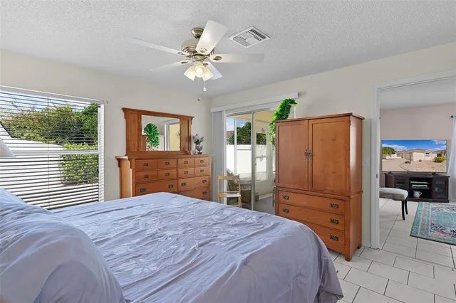 a bedroom with a bed dresser and a window