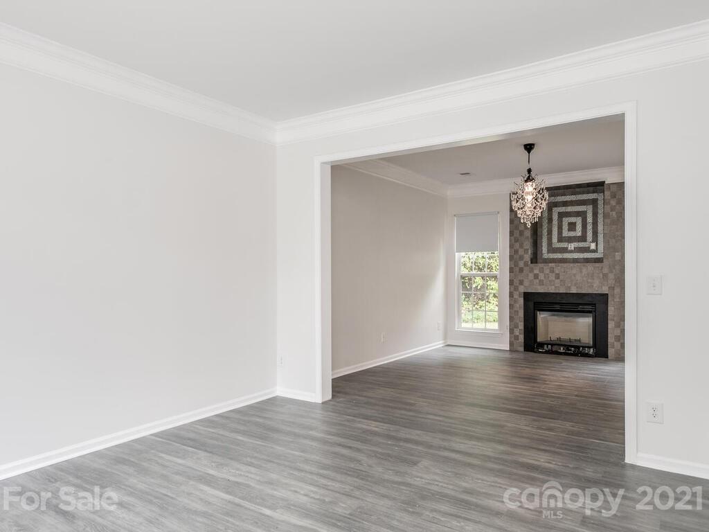 1108 Hannah Rae Court Charlotte, NC 28214 - Photo 4 of 16 a view of a livingroom with wooden floor and a fireplace