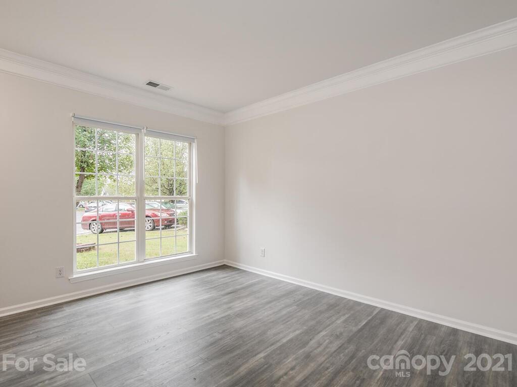 1108 Hannah Rae Court Charlotte, NC 28214 - Photo 5 of 16 an empty room with wooden floor and windows