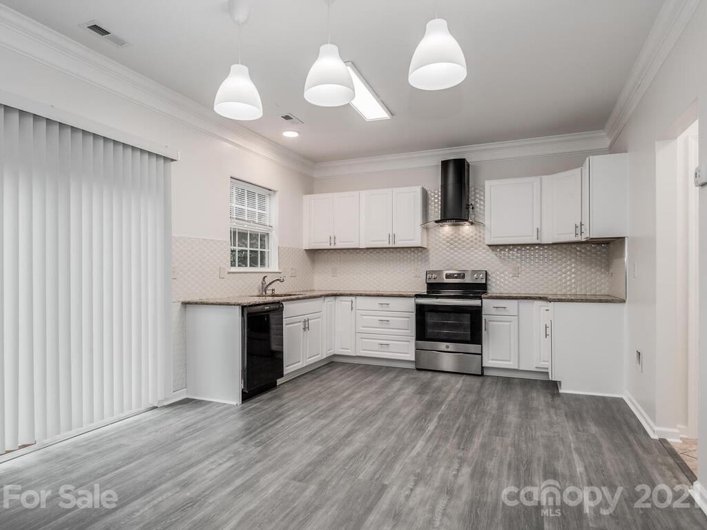 1108 Hannah Rae Court Charlotte, NC 28214 - Photo 8 of 16 a kitchen with a refrigerator and a stove top oven