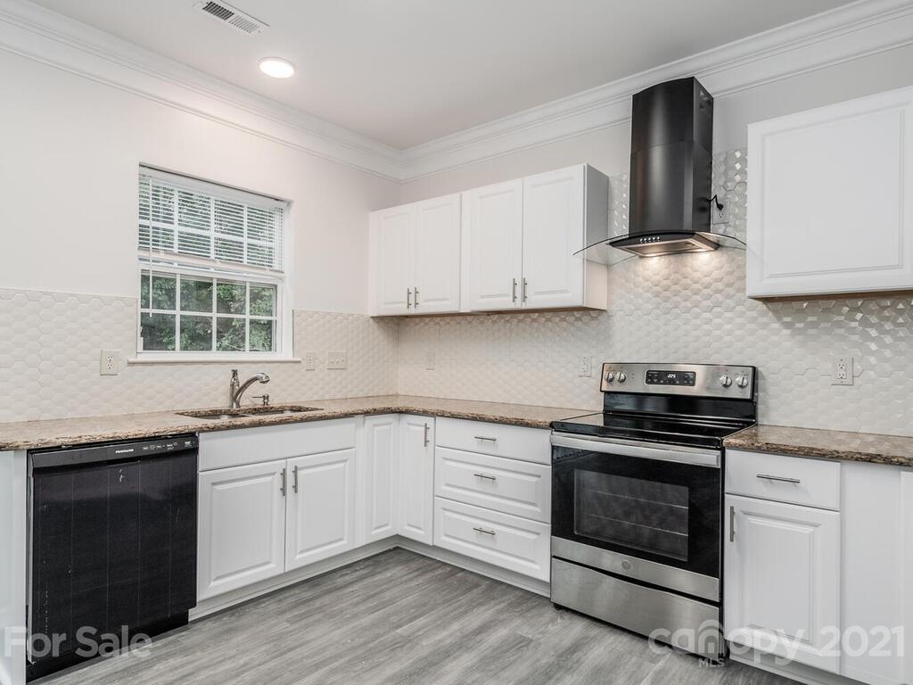 1108 Hannah Rae Court Charlotte, NC 28214 - Photo 9 of 16 a kitchen with stainless steel appliances granite countertop a stove sink and cabinets