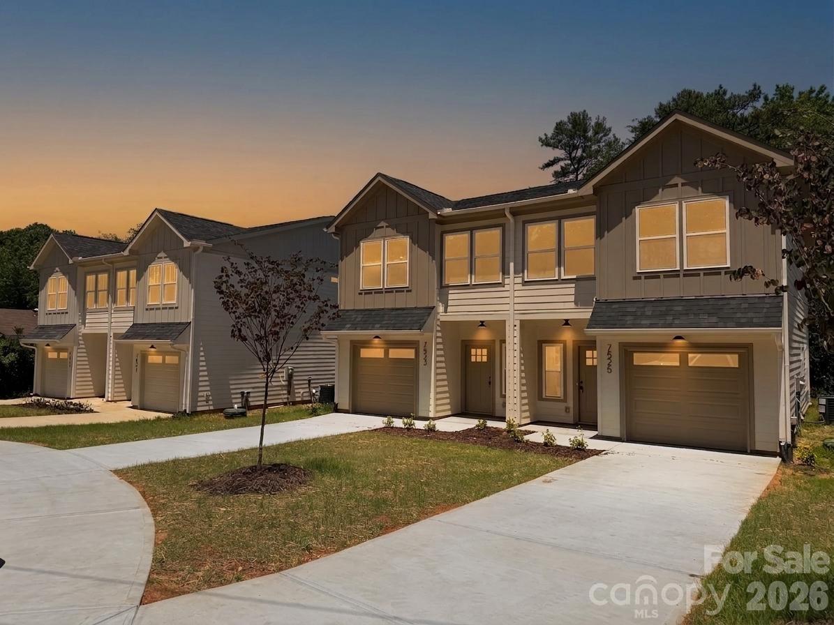 7521 Lawyers Road Charlotte, NC 28227 - Photo 28 of 35 a front view of a house with a yard and garage