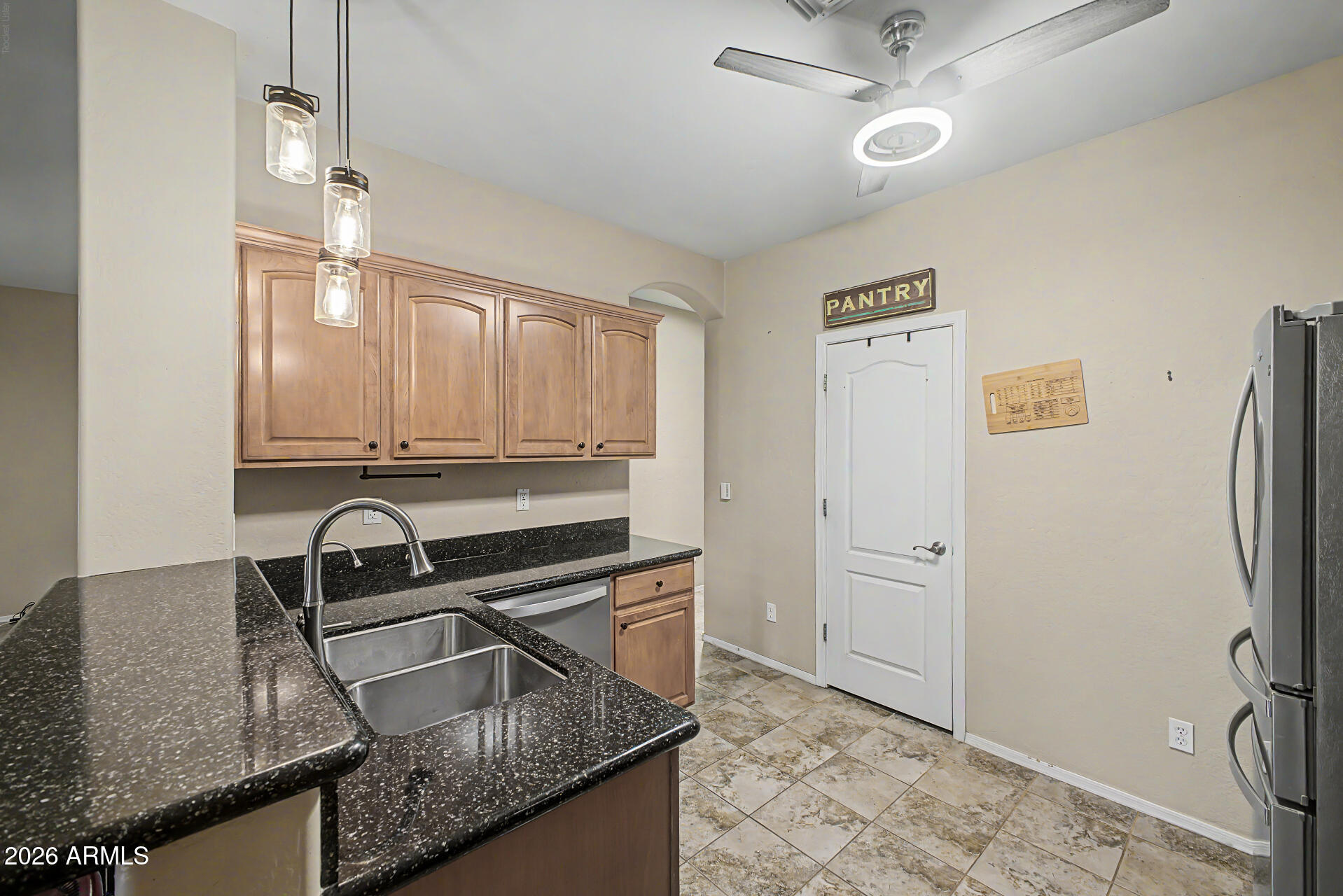 2600 East Springfield Place, Unit 109 Chandler, AZ 85286 - Photo 11 of 38 a kitchen with granite countertop a sink appliances and cabinets