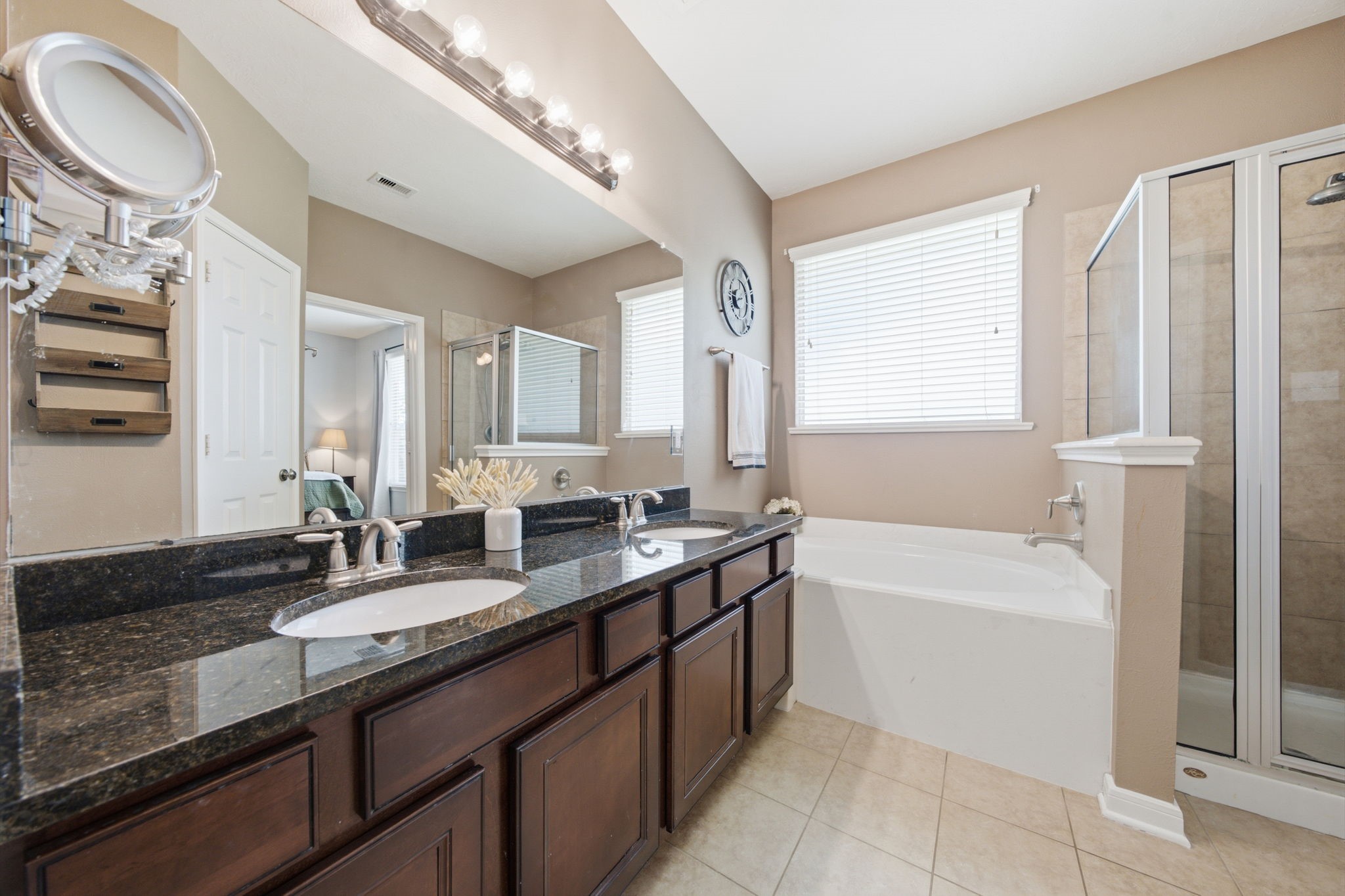 8911 Henrico Lane Rosenberg, TX 77469 - Photo 15 of 45 a bathroom with a granite countertop sink mirror and a bathtub