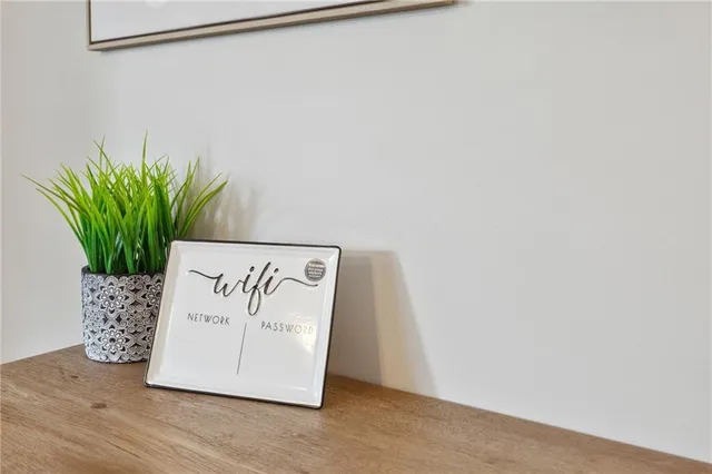 an empty room with wooden floor and mirror