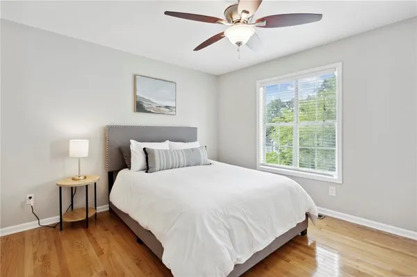 a bedroom with a bed and a lamp