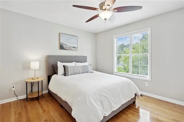 a bedroom with a bed and a lamp