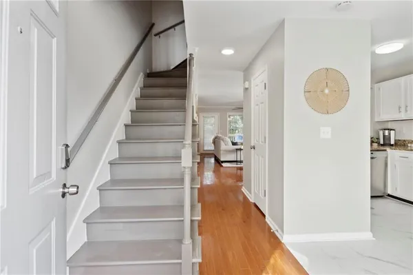 a view of entryway and hall with wooden floor