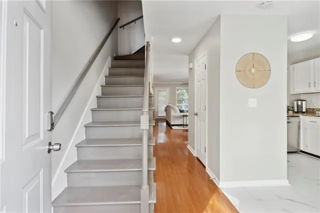 a view of entryway and hall with wooden floor