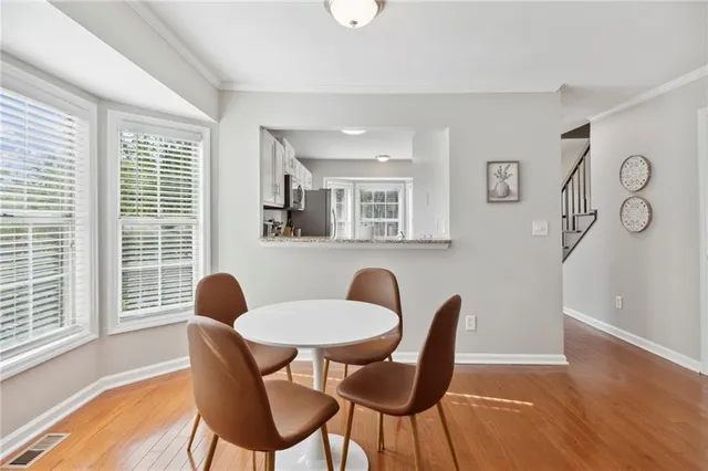 a dining room with furniture and wooden floor