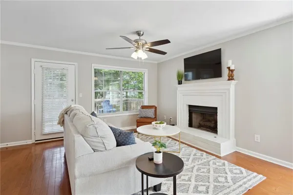 a living room with furniture a fireplace and a flat screen tv