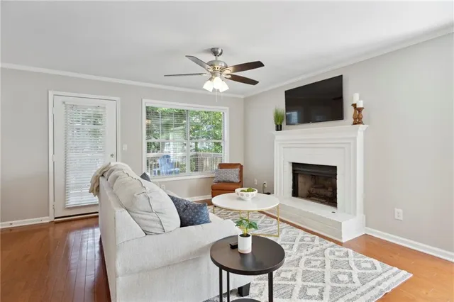 a living room with furniture a fireplace and a flat screen tv