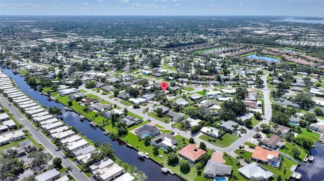 a view of a house with a yard and tree s