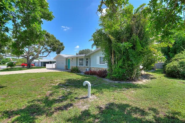 a front view of a house with a garden and yard
