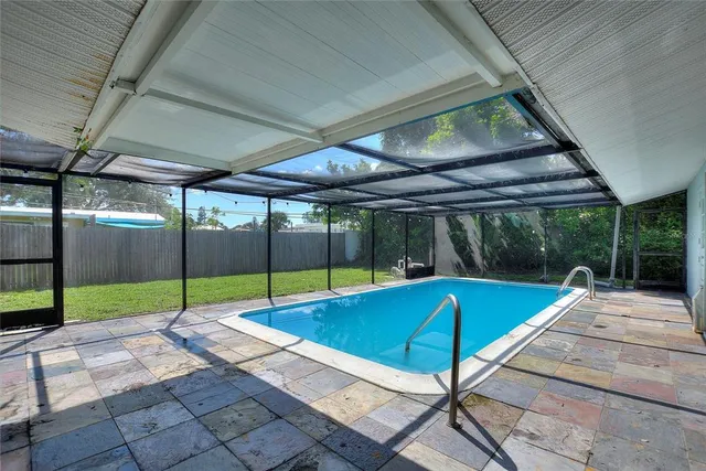 a view of a backyard with table and chairs and a barbeque