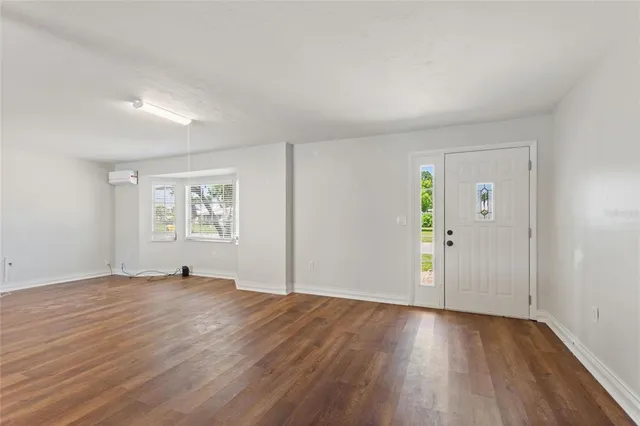 a view of an empty room with wooden floor