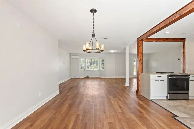 a kitchen with a refrigerator and white cabinets