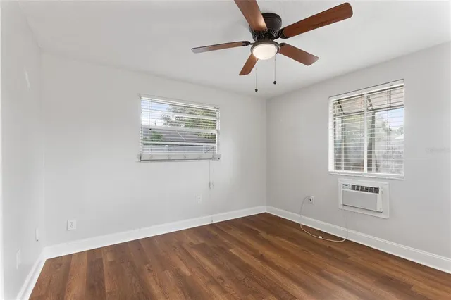 a view of a livingroom with a ceiling fan and wooden floor