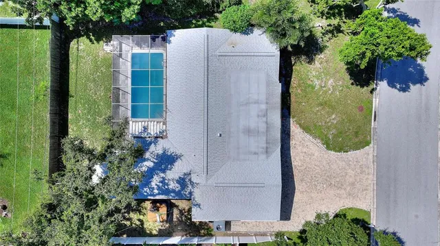 an aerial view of a residential houses with yard