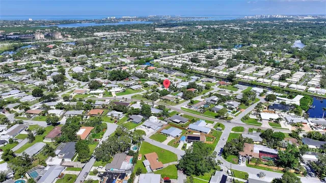 an aerial view of residential houses with city view
