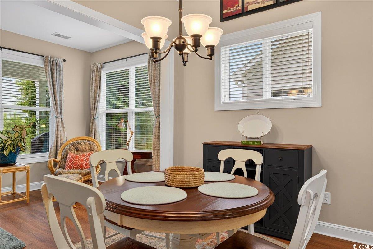 1719 Maplecress Way Myrtle Beach, SC 29577 - Photo 11 of 40 Dining area with a chandelier, healthy amount of natural light, and dark wood-type flooring