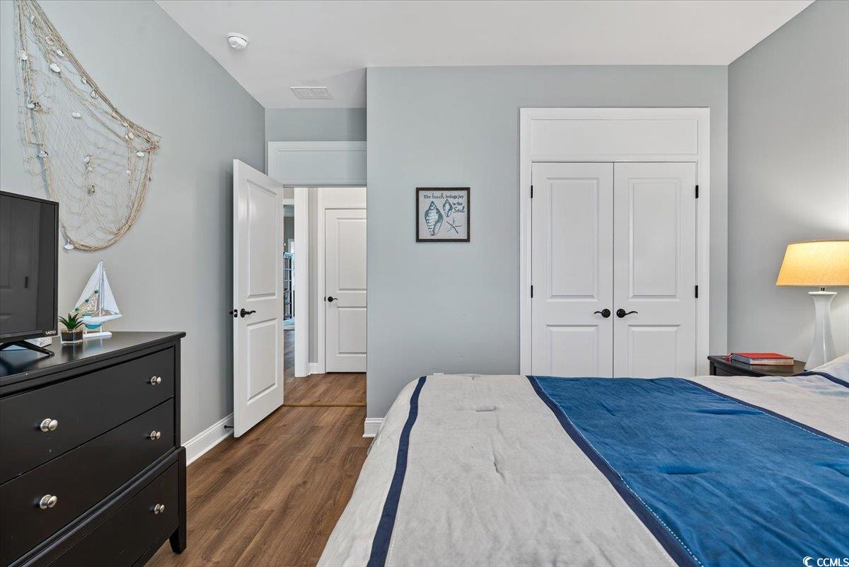 1719 Maplecress Way Myrtle Beach, SC 29577 - Photo 25 of 40 Bedroom featuring dark wood-type flooring and a closet