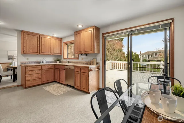 a kitchen with a table chairs stove and cabinets