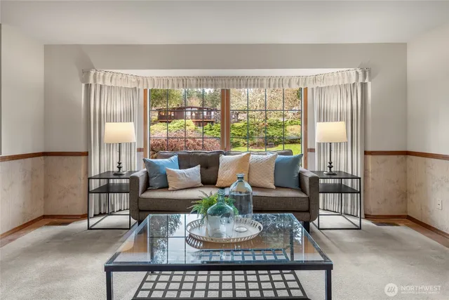 a living room with furniture and a floor to ceiling window
