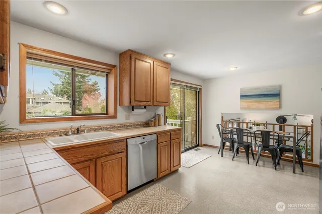 a kitchen with stainless steel appliances granite countertop sink stove and table