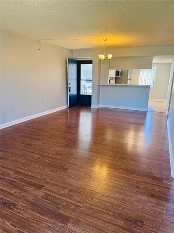 a view of a living room with kitchen and fireplace
