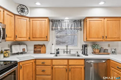 a kitchen with stainless steel appliances a sink and cabinets