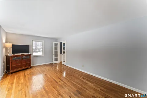 a view of empty room with wooden floor and cabinet